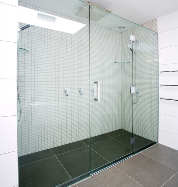 Inline showers can span the width of a bathroom and makes for a formal look. Image source:  Euro Glass