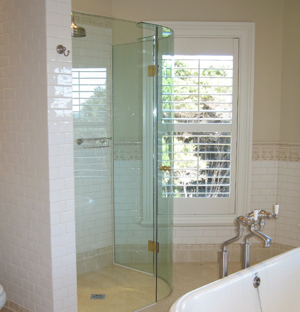 The side panels of quadrant showers are custom sized according to your shower space.  Image source:  Euro Glass